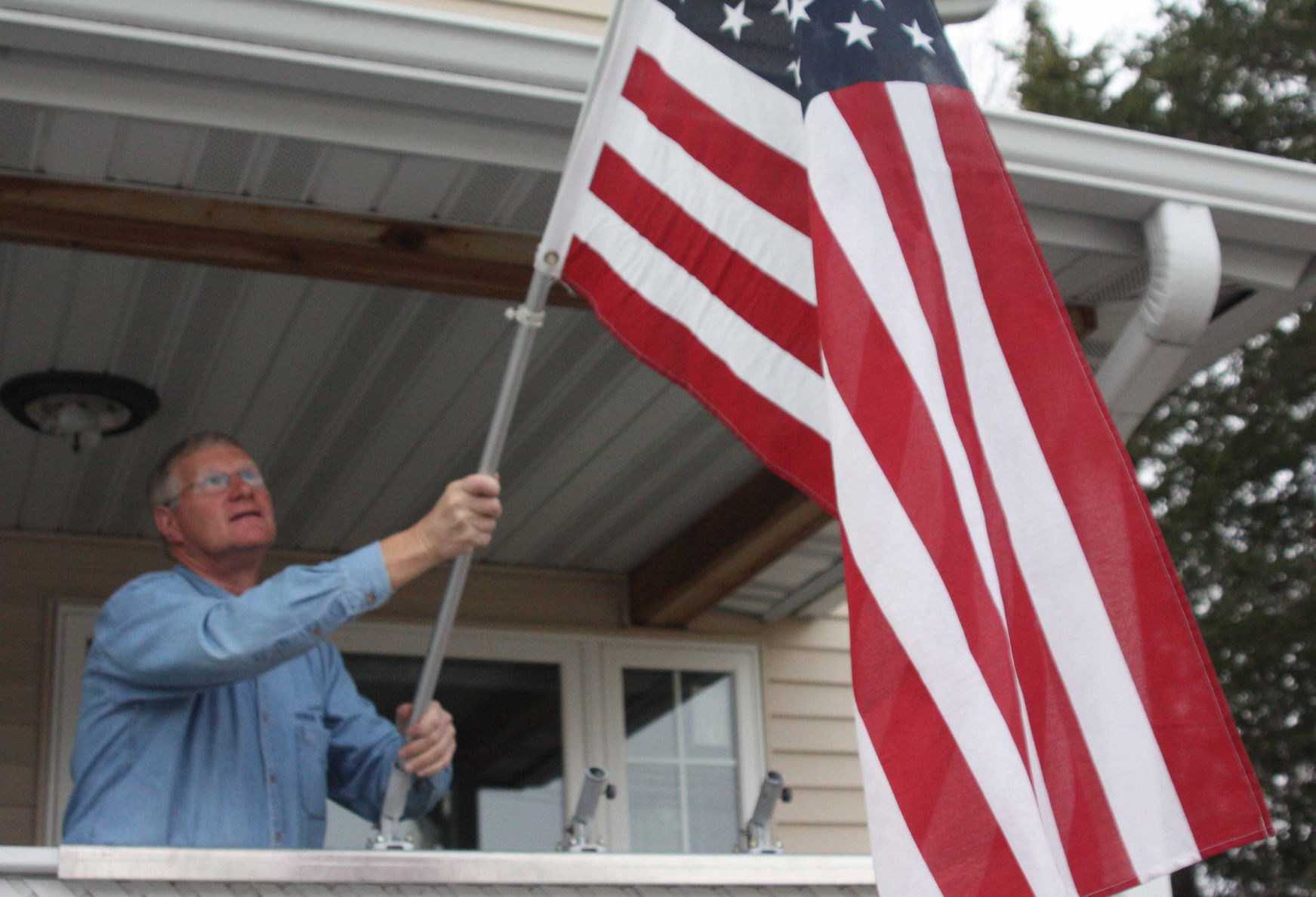 Howard Marklein puts up American flag picture (copy)
